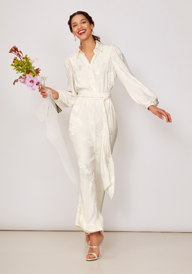 Bride clutching flowers wears Kitri Studio playsuit