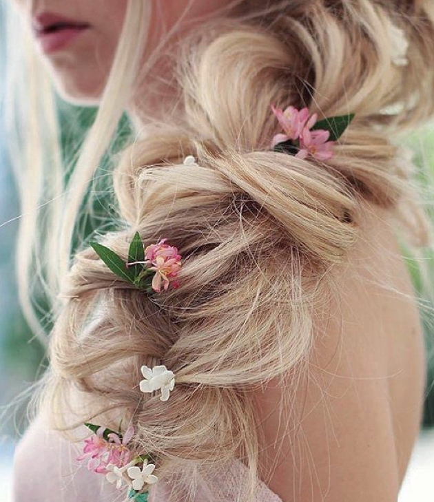 Close up of blonde bridal hair with extensions from Foxy Locks and pink flowers