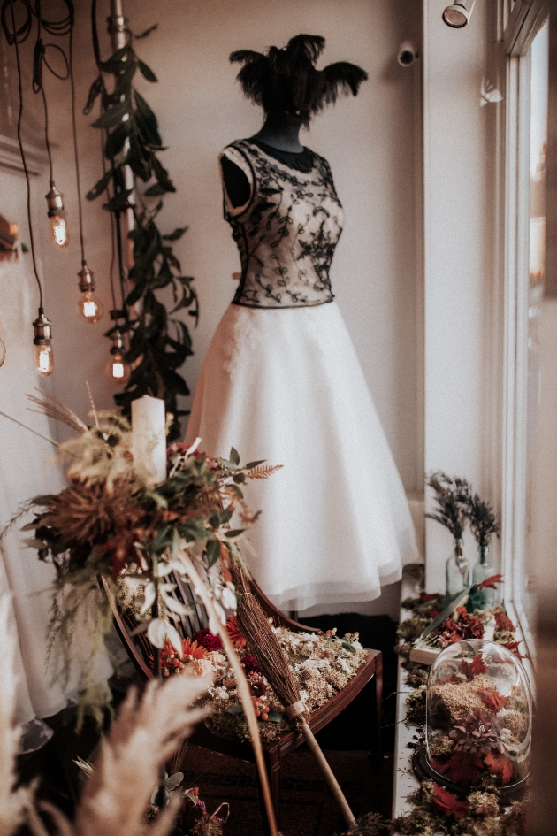 Window display of The Bride Shop with Hallooween autumnal display and black lace detail dress