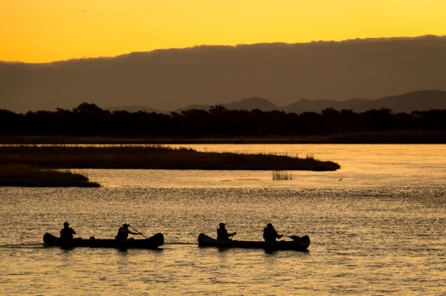 Two canoes on a lake at sunset