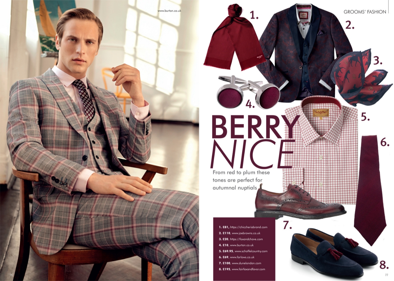 Male model in a check suit sitting on a chair with berry-coloured accessories