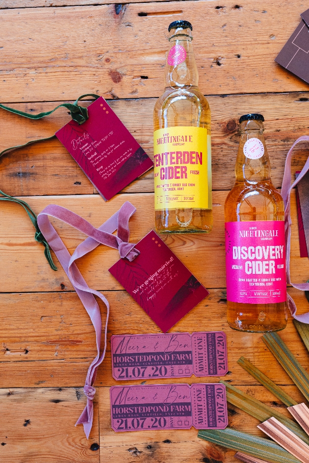 festival ticket style wedding invitations and bottles of tenterden cider