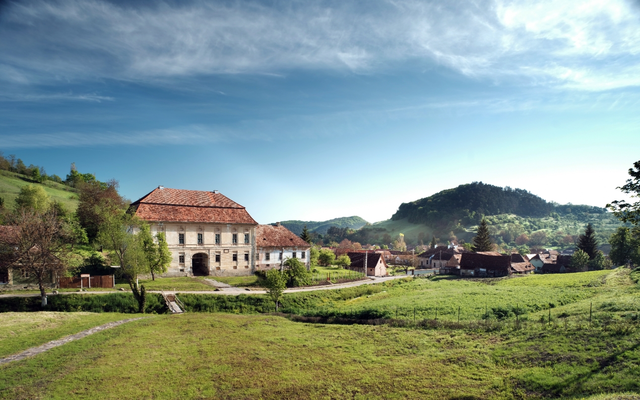 Gothic looking home in Transylvania with mountains in the background