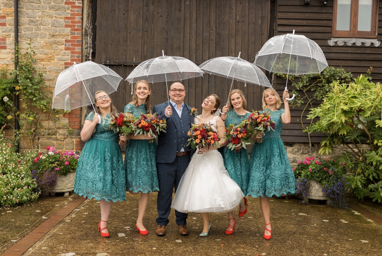 Newlyweds pose with bridesmaids