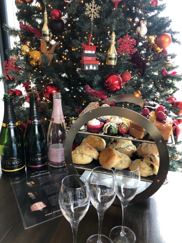 Tinwood's sparkling afternoon tea in front of christmas tree