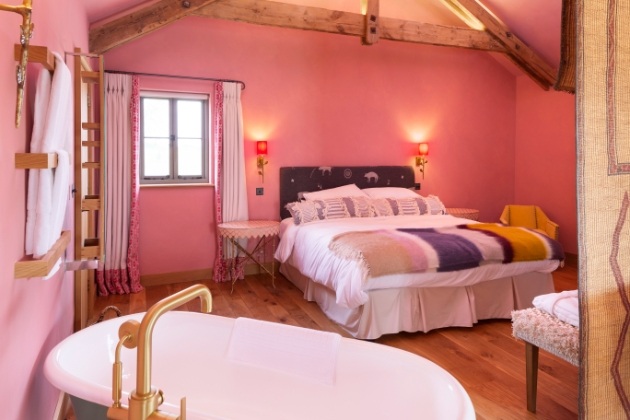 bedroom in cottage pink walls rustic