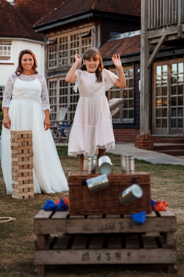 bride and flowergirl playing lawn games