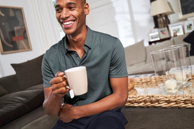 man in loungewear sitting at table with coffee