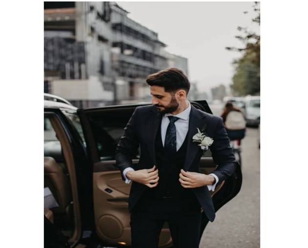 black and white suit on model getting out of car