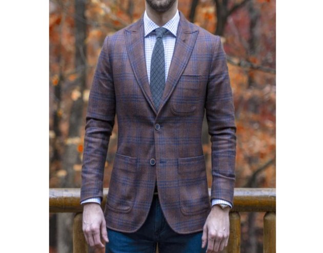 man in checked suite jacket and tie