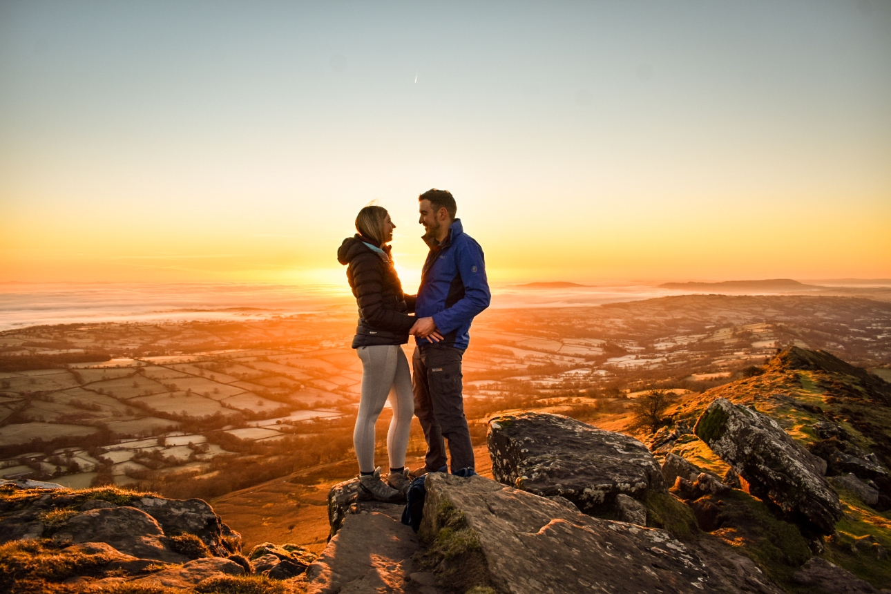 couple on rocks in hertfordshire at sunset