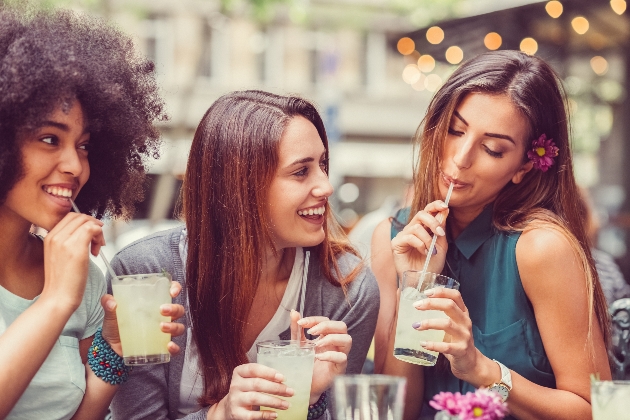 three ladies drinking cocktails