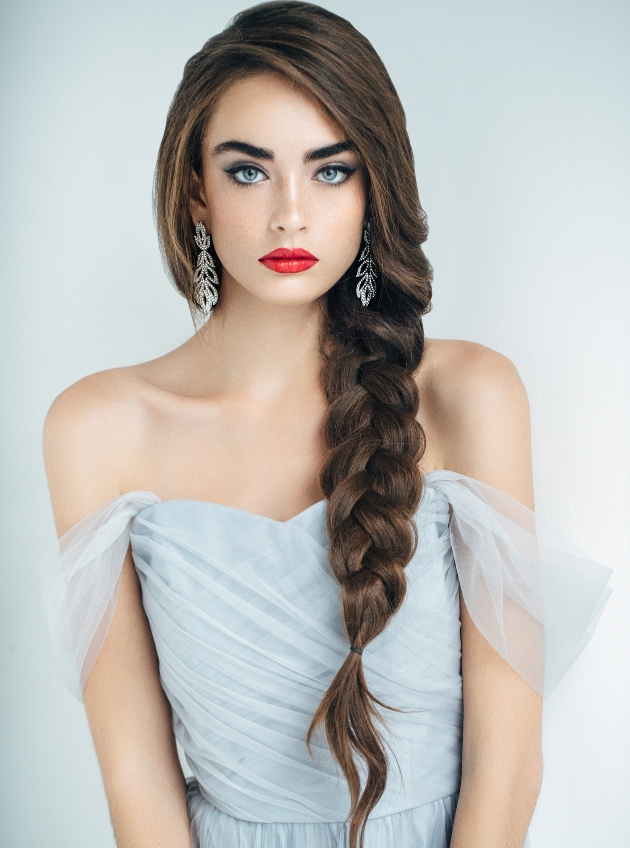 bride in a pale blue dress with a side braid.