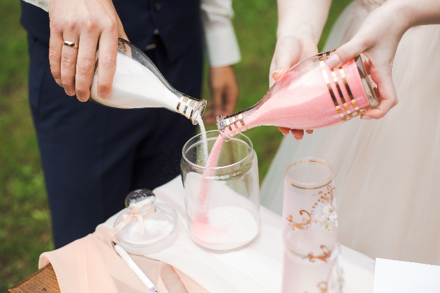 sand ceremony using pink and white sand