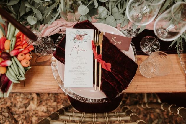 close up of place setting with gold cutlery and wedding breakfast menu design