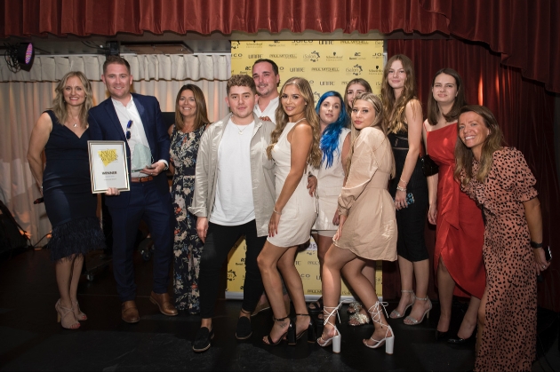 The salon team at Q Hair and Beauty collecting their award
