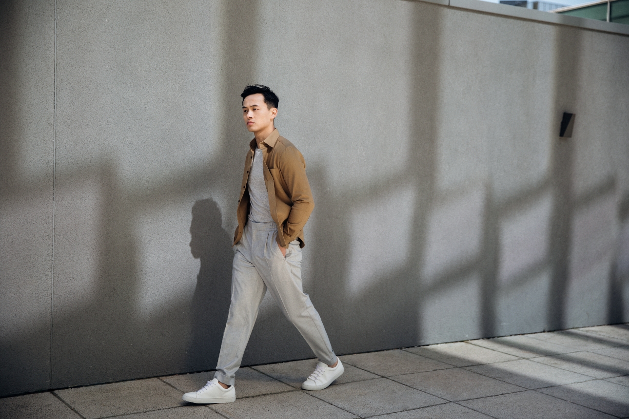 model walking down road in jacket and joggers