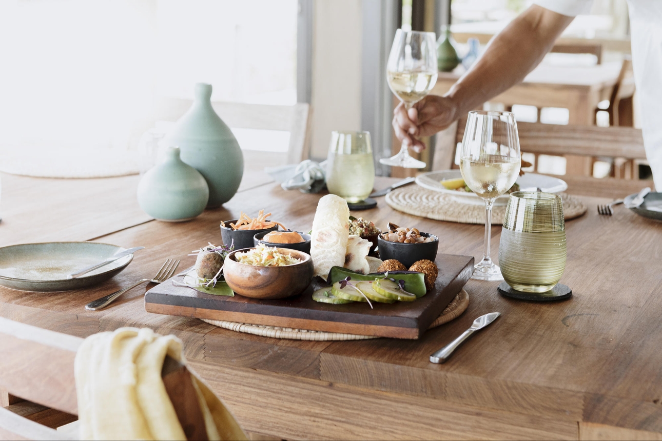 dinner table with african food and wine