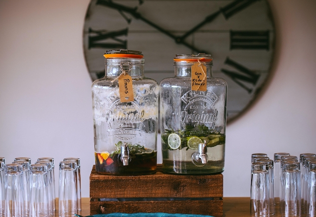 two glass drinks kegs with glasses on a table