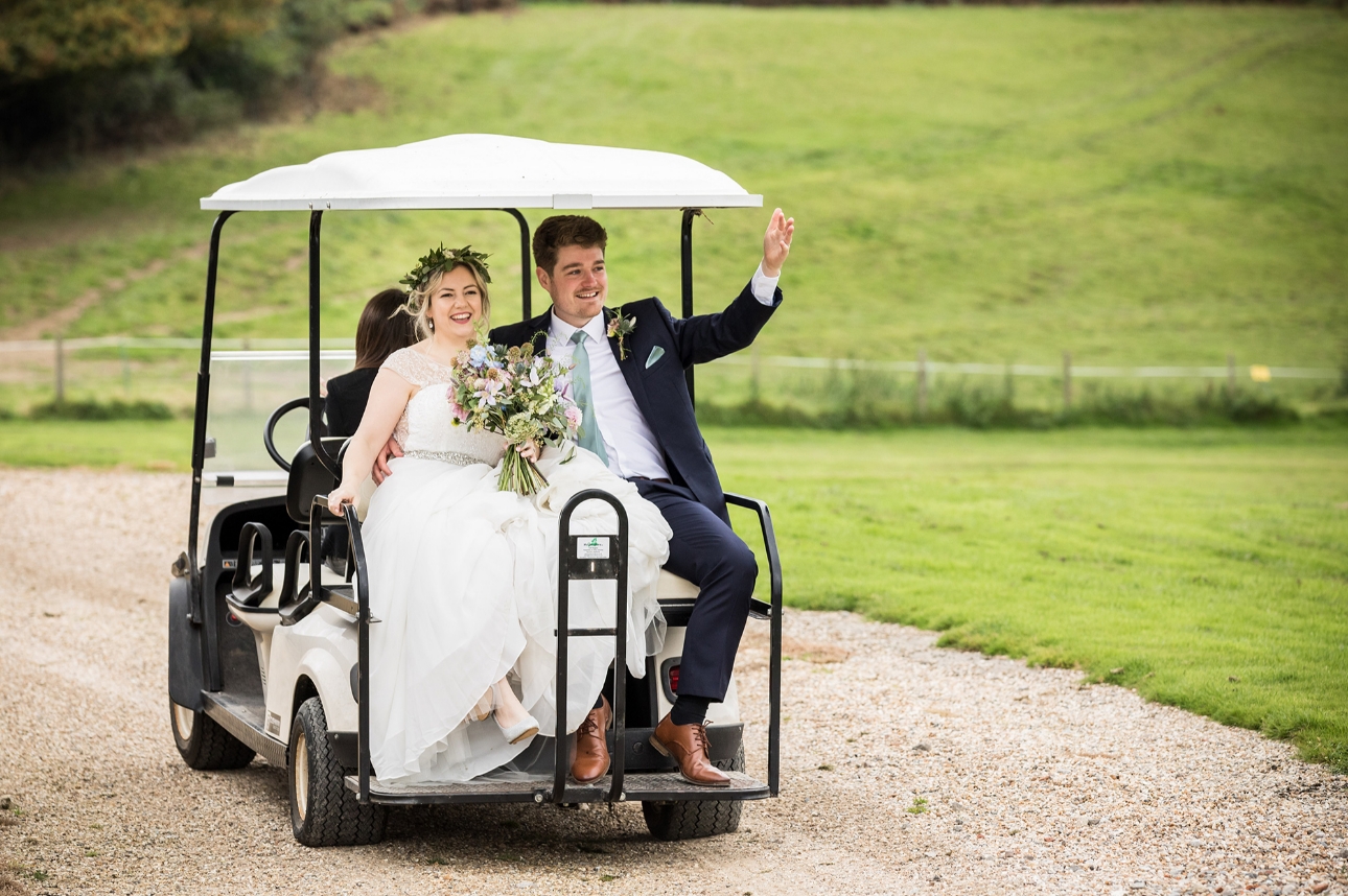 Couple ride golf cart