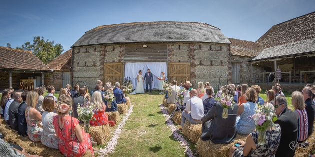 Couple getting married outside at Peelings Manor Barns
