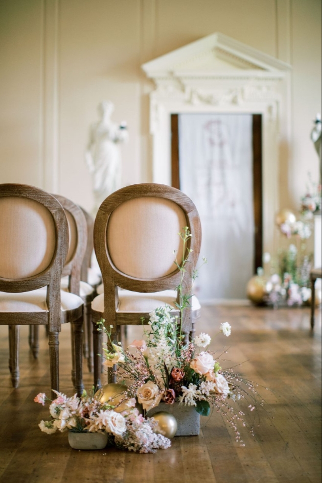 Ceremony set up with pew end floral arrangements