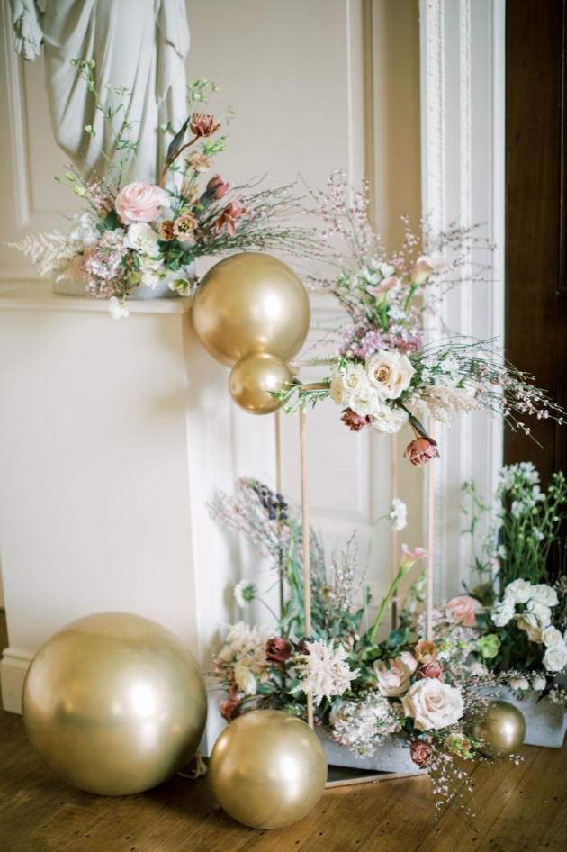 wedding venue styling focal point with metallic balloons and pink flowers