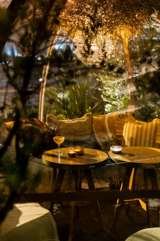 shot through glass igloo looking at table and chairs soft lighting