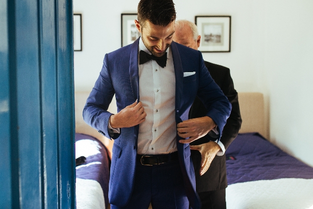 Man trying on a navy suit