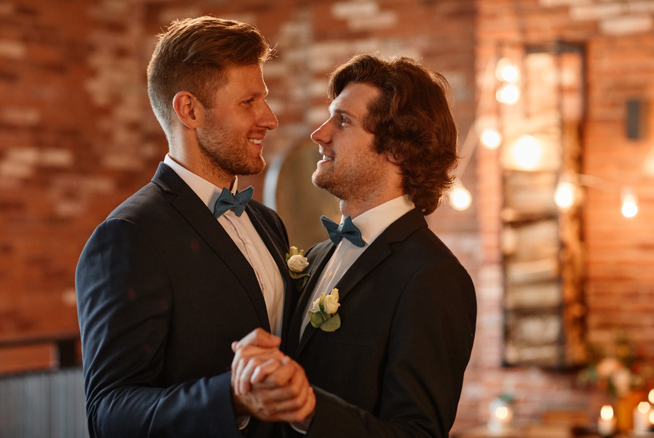 two grooms dancing