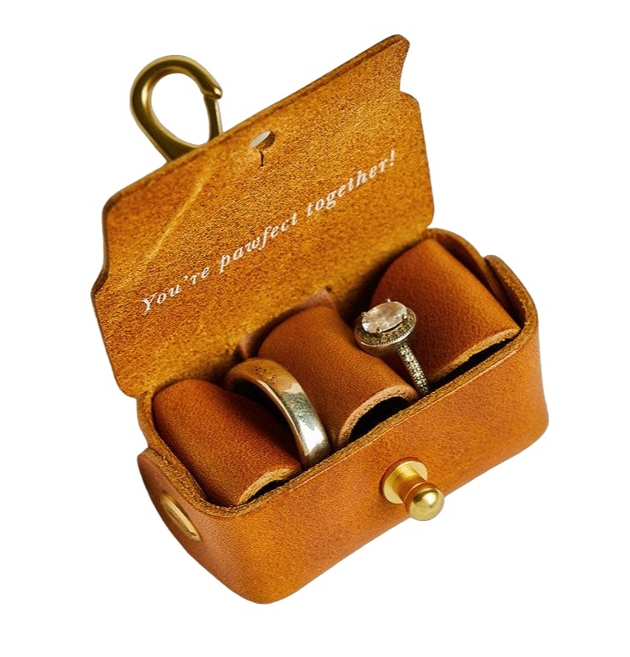 open brown leather ring box showing rings inside