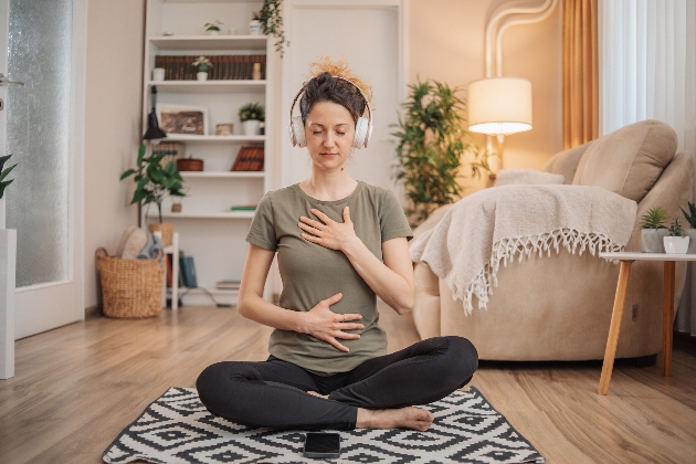 woman sat on floor with headphones on