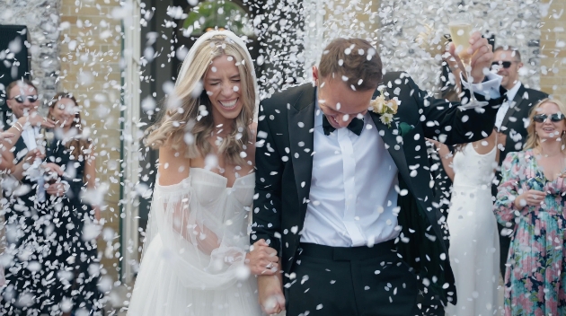 Bride and groom leaving ceremony in a shower of confetti
