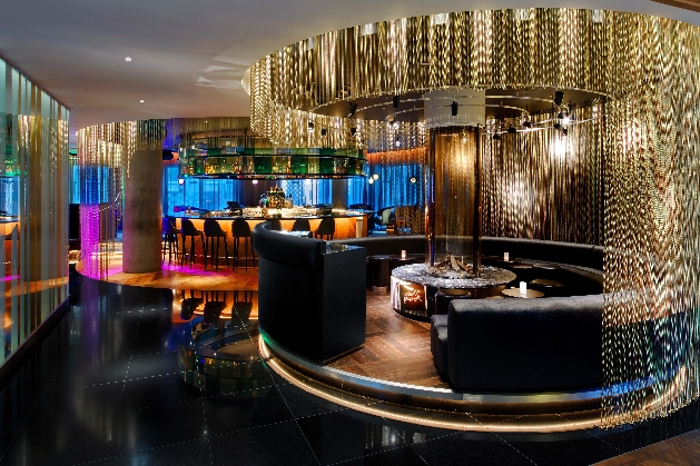 circular table and seating with hanging installation in modern brasserie