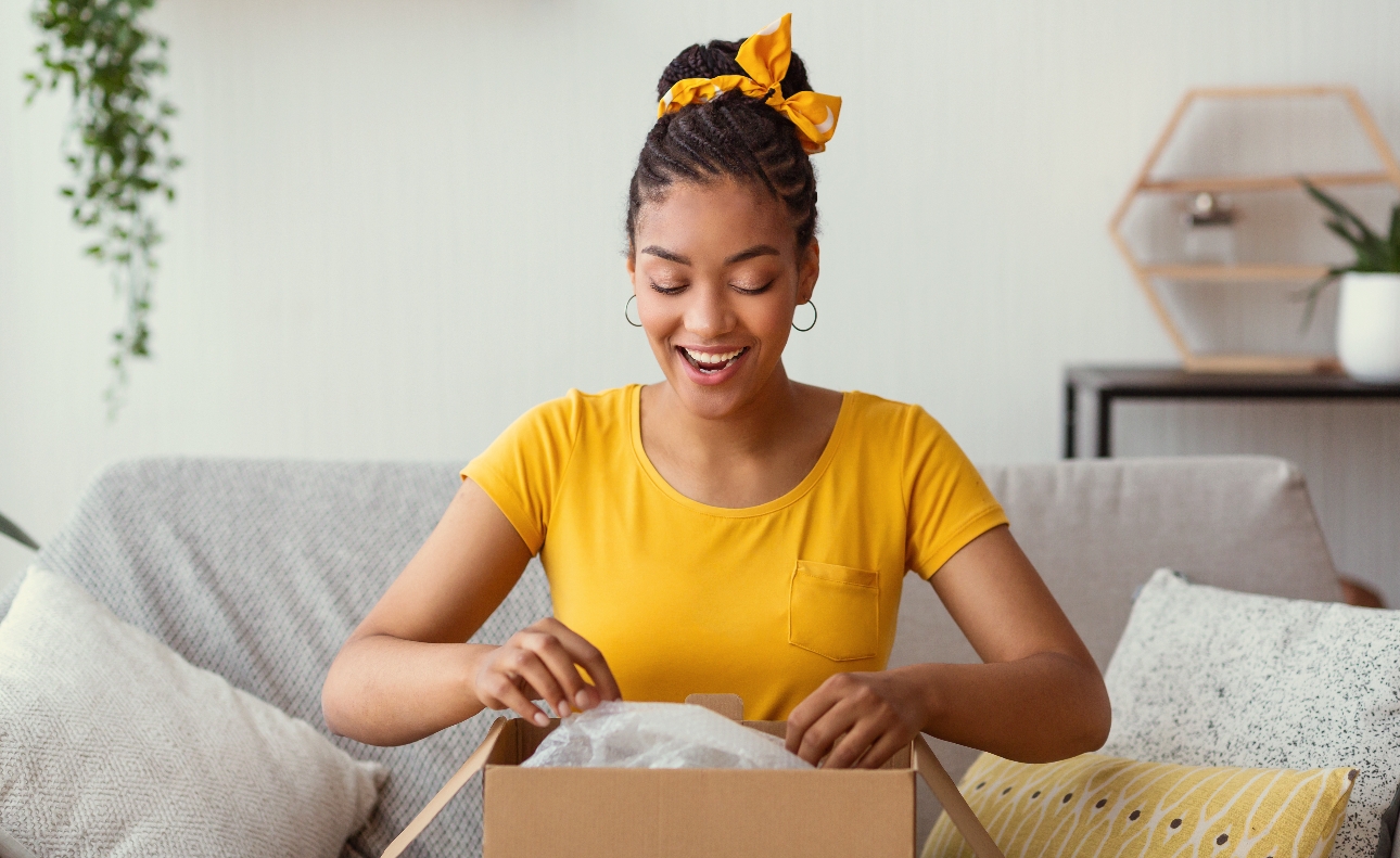 woman at home opening a gift