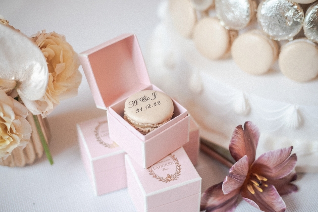 vanilla macaron with name and date on in a pink box