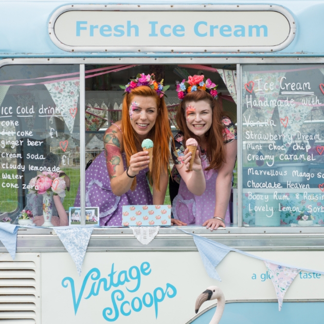 two women in a vintage ice cream van wearing flower crowns Leonardslee