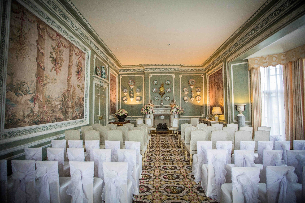 long ceremony room pastel colours tapestry on walls french windows