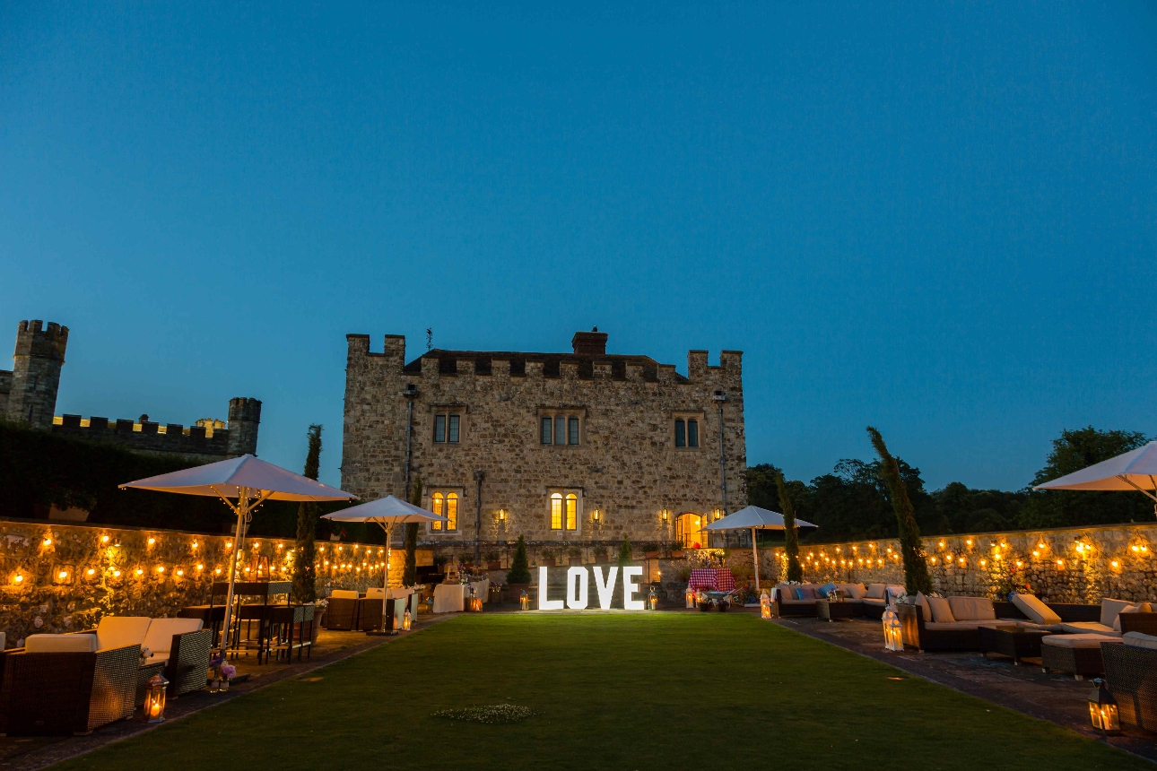 historic building at night with garden an outdoor seating