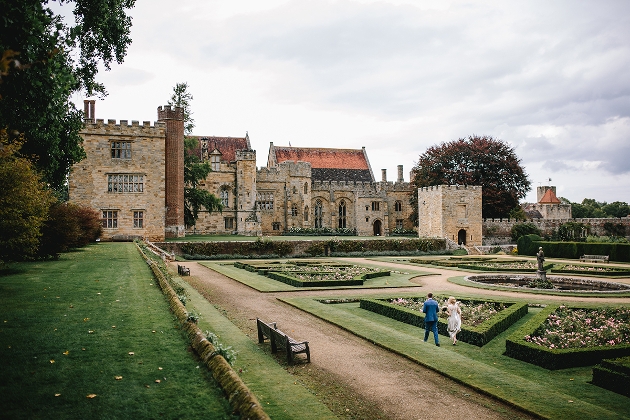 Penshurst Place bride and groom in gardens walking to manor house