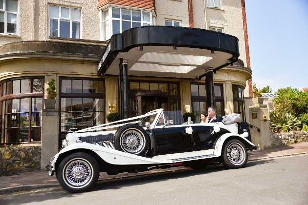 Bride and groom in a wedding car outside Hydro Hotel Eastbourne