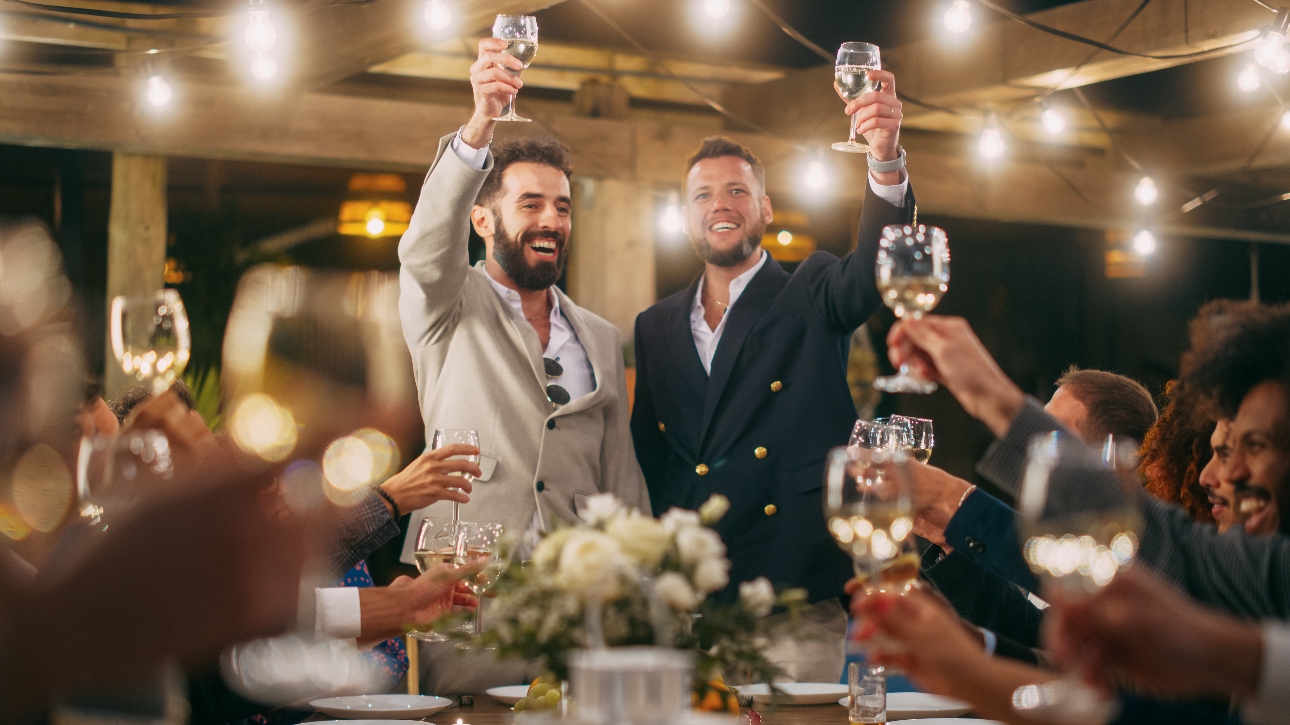 two men in suits having a toast