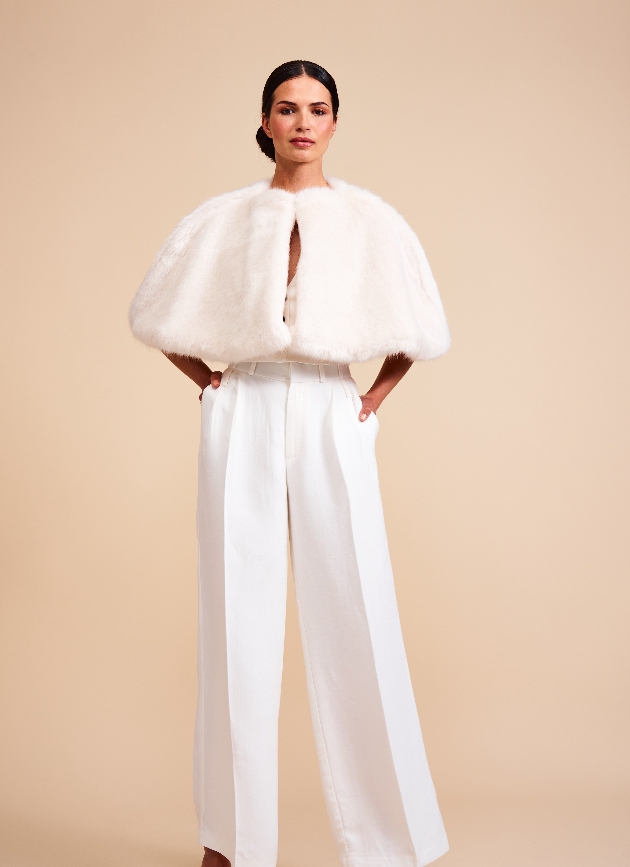 wide leg tailored trousers wearing fur bolero cape