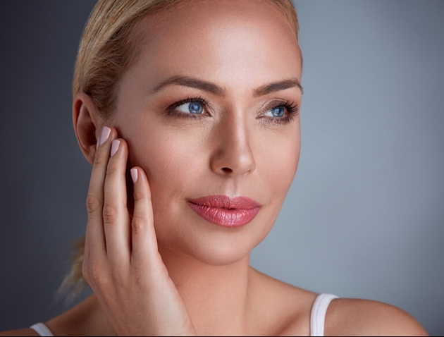 close up image of a woman with hand on her face