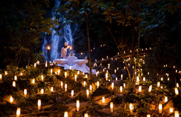 A private dinner in the middle of the forest surrounded by hundreds of candles