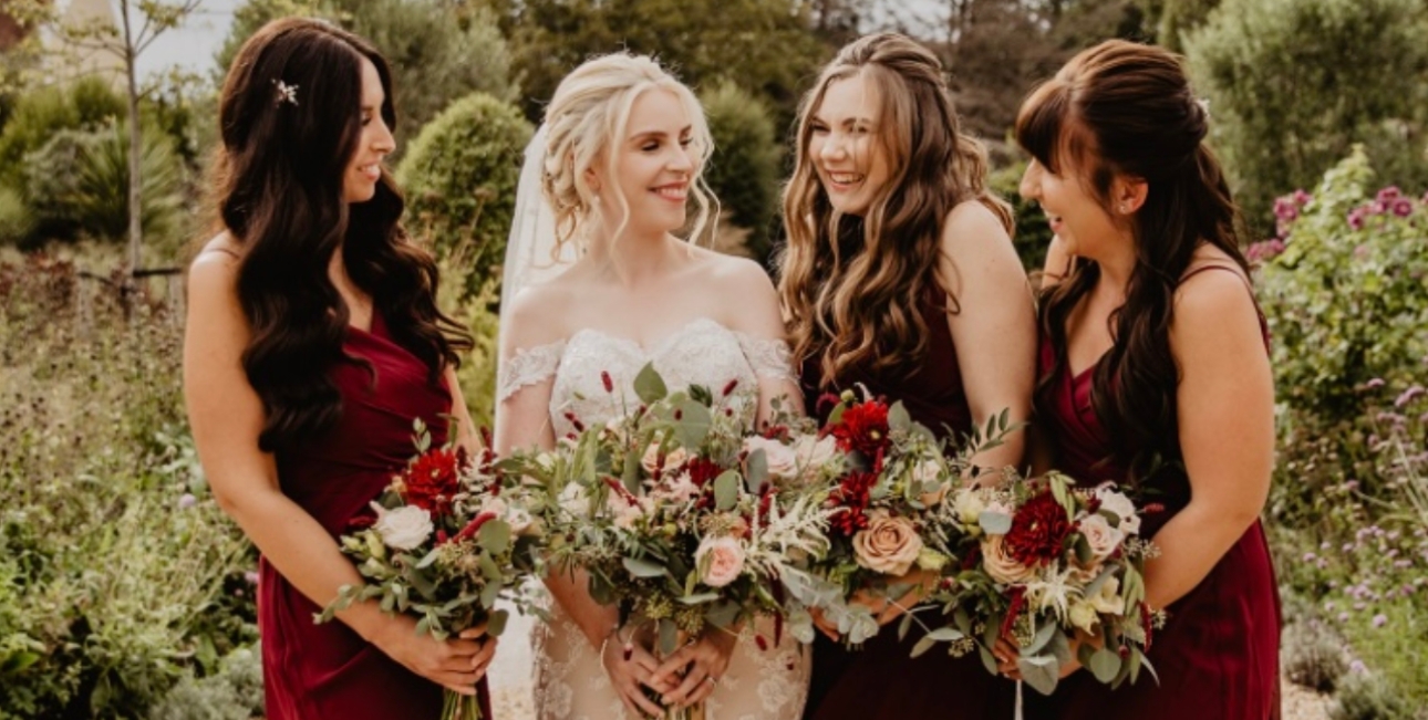 Bride, bridesmaids in burgundy with matching bouquest