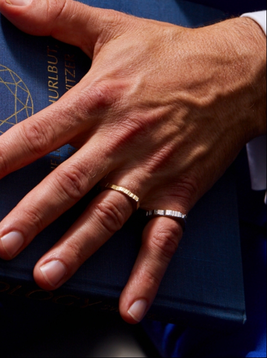 A man wearing two rings