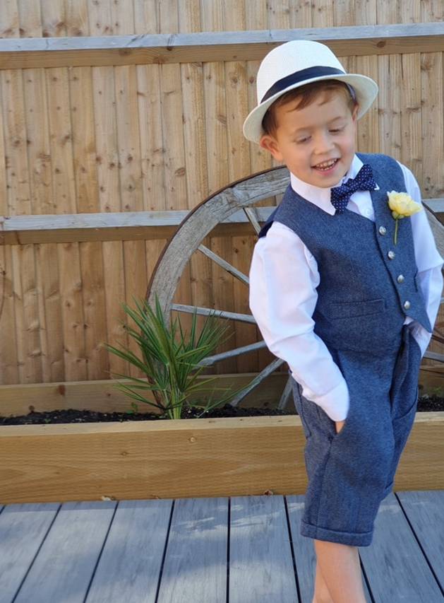 pageboy in white shirt, waistcoat and shorts