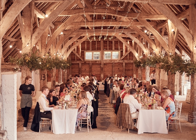 Guests gathered for a wedding reception at Sullington Great Barn