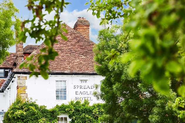 The Spread Eage Hotel & Spa exterior viewed through leafy trees